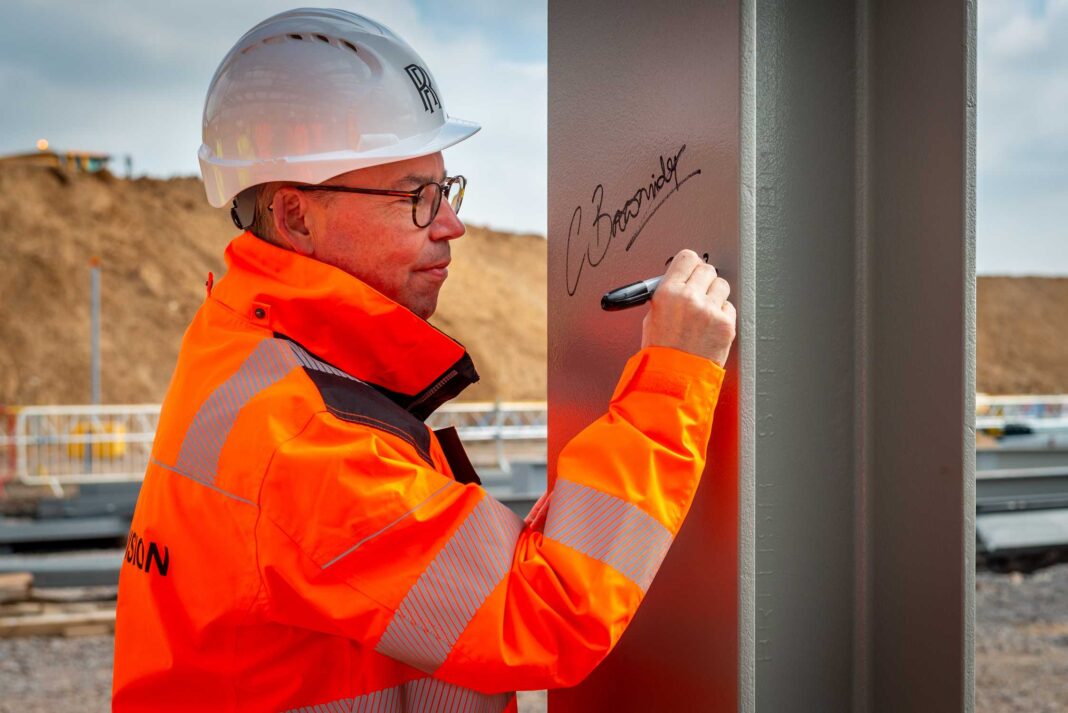CHIEF EXECUTIVE SIGNS OFF FIRST ABOVE-GROUND CONSTRUCTION AT EXTENSION TO HOME OF ROLLS-ROYCE